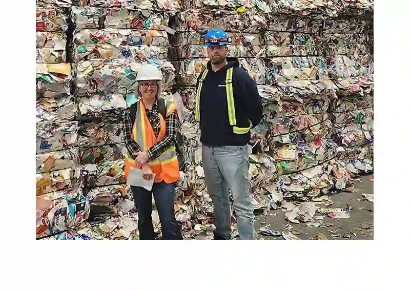 Isabelle Faucher stands in front of carton bales with Marc-André Lavoie of Société VIA, at the Lachine MRF in Montréal
