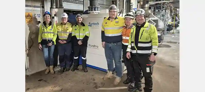 Visy and Runtech teams photographed next to a RunPro Turbo Compressor.