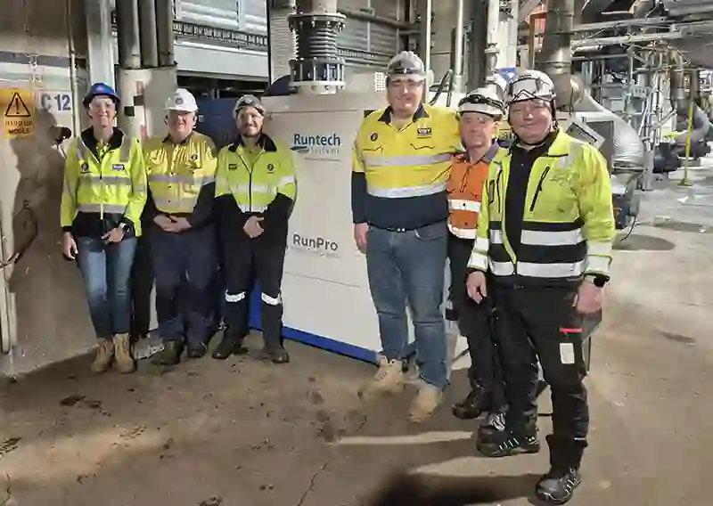 Visy and Runtech teams photographed next to a RunPro Turbo Compressor.